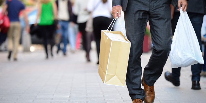 Suit with shopping bags on shopping street, Amsterdam, the Netherlands